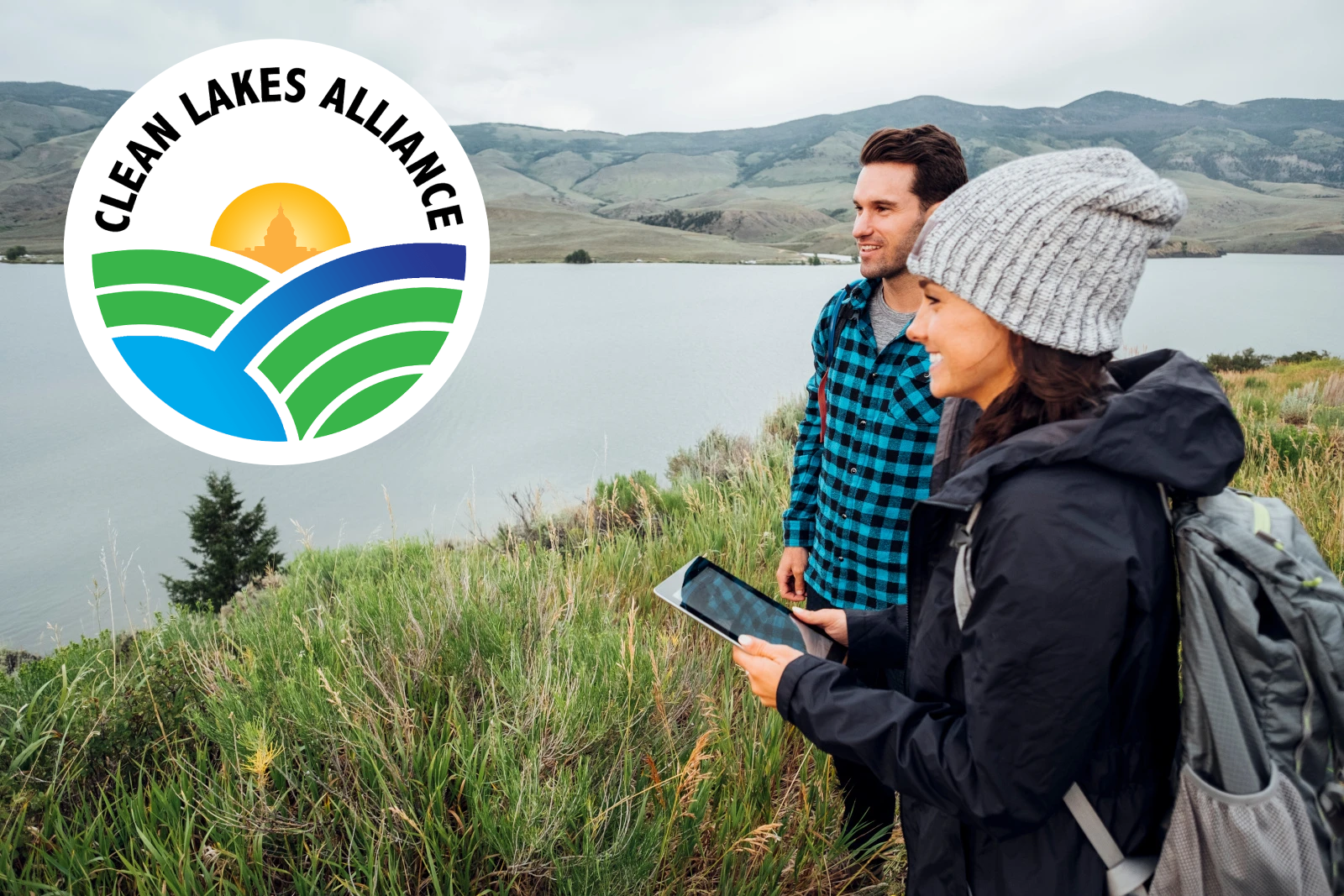 Image of a woman interviewing a man with smart device standing beside a lake: the NestForms Offline Survey App