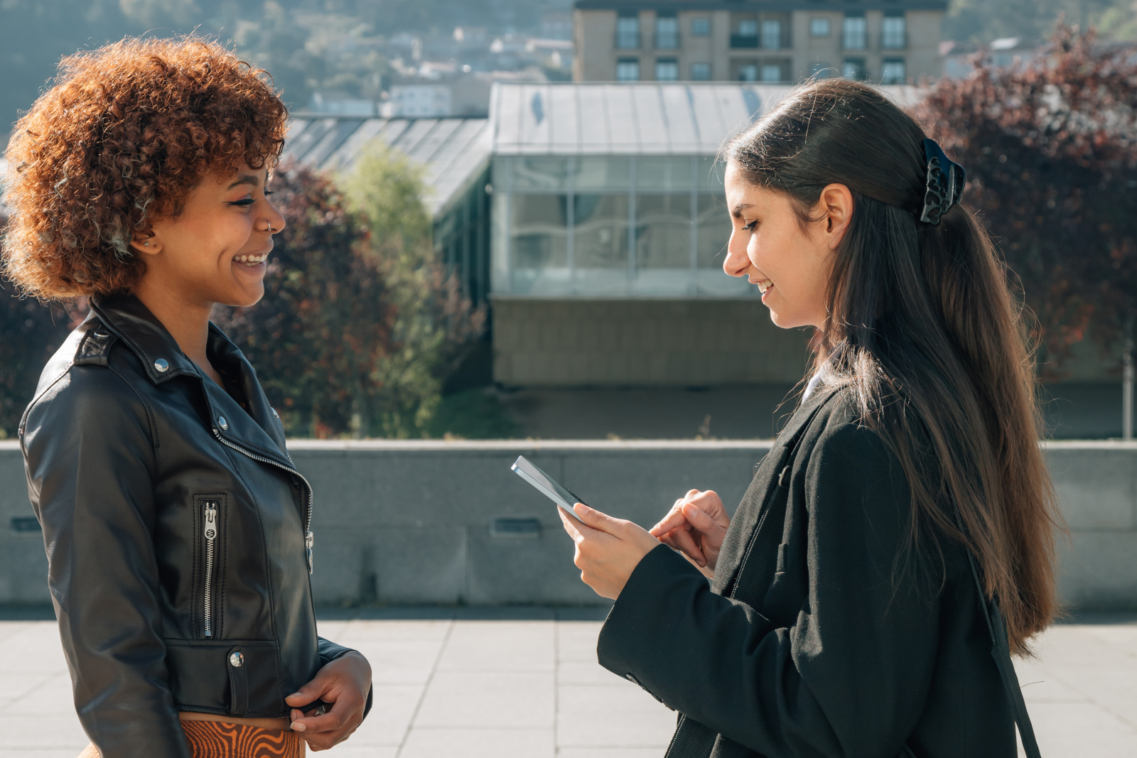 Woman being interviewed for marketing survey in street with the NestForms Mobile Data Collection App 