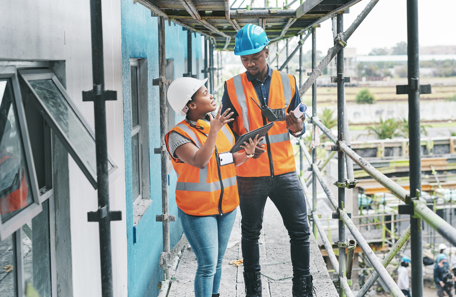 Two site managers with smart device working on a construction snag list: The NestForms new build snagging checklist app