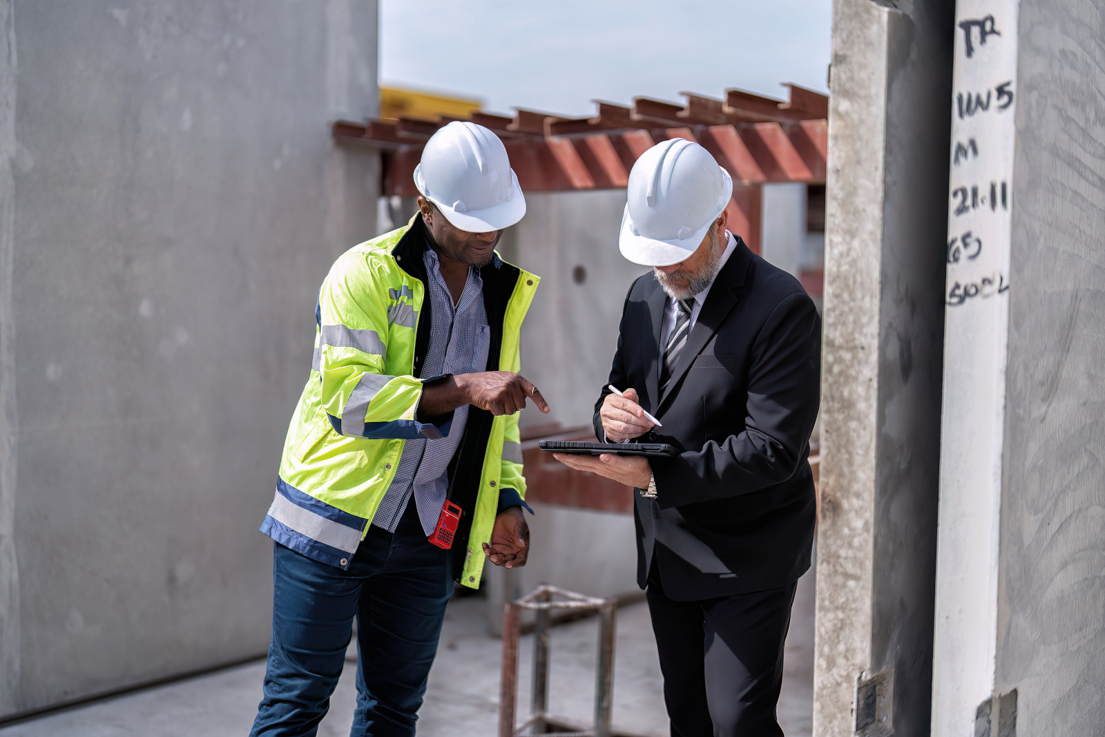 Two engineers at construction site working on a Project Handover Checklist: The NestForms Android forms app
