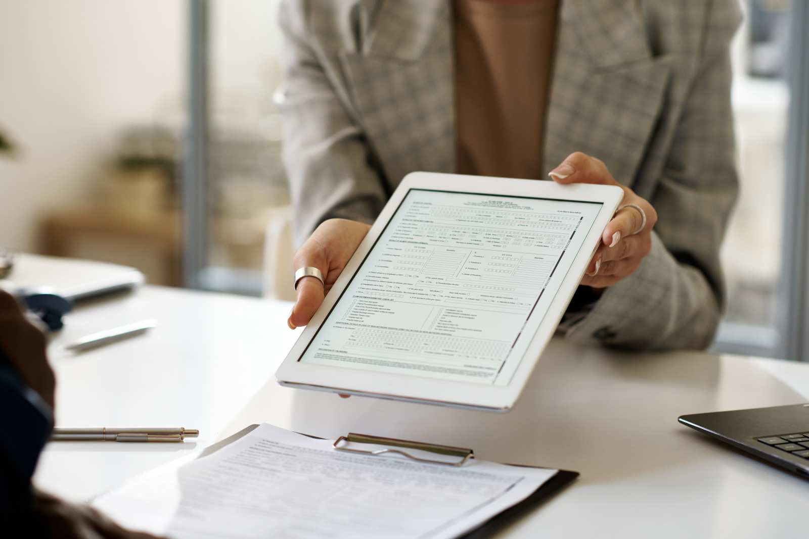 Within the NestForms app, a Business woman showing PDF document to client on smart device: The NestForms offline survey app