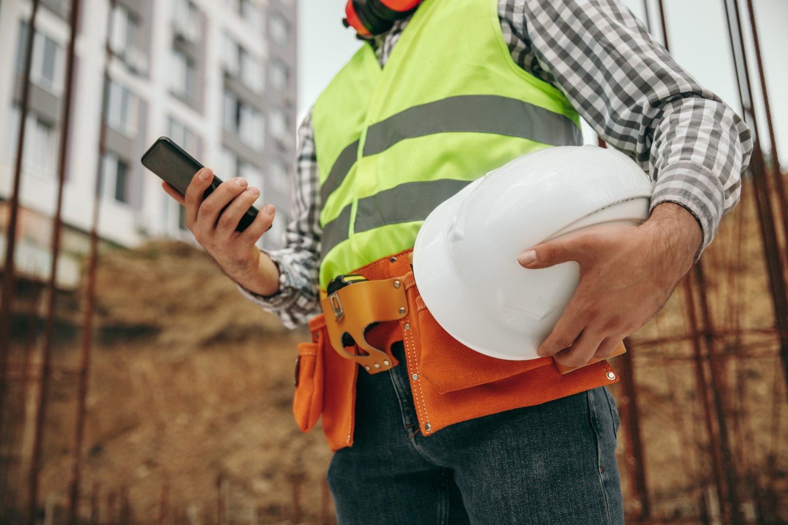 Health and Safety inspector in large warehouse with smart device