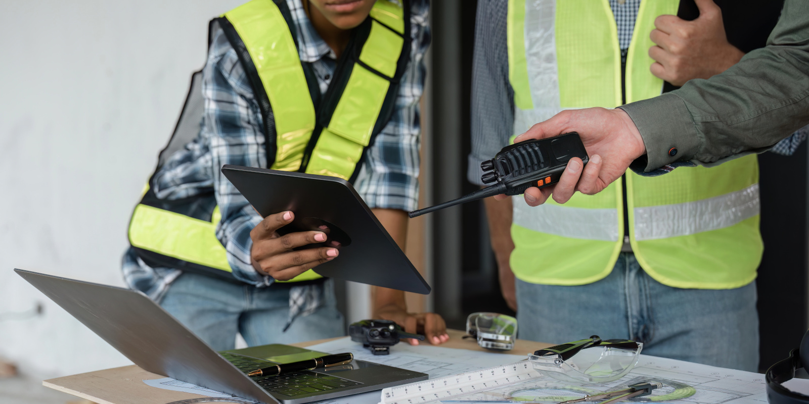 Construction managers with tablet sharing the details within a Site Handover Form created on the NestForms offline survey app