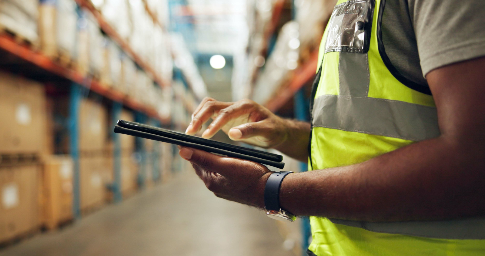 Warehouse worker wearing hi-vis vest and using a smart device: the NestForms Mobile Survey App