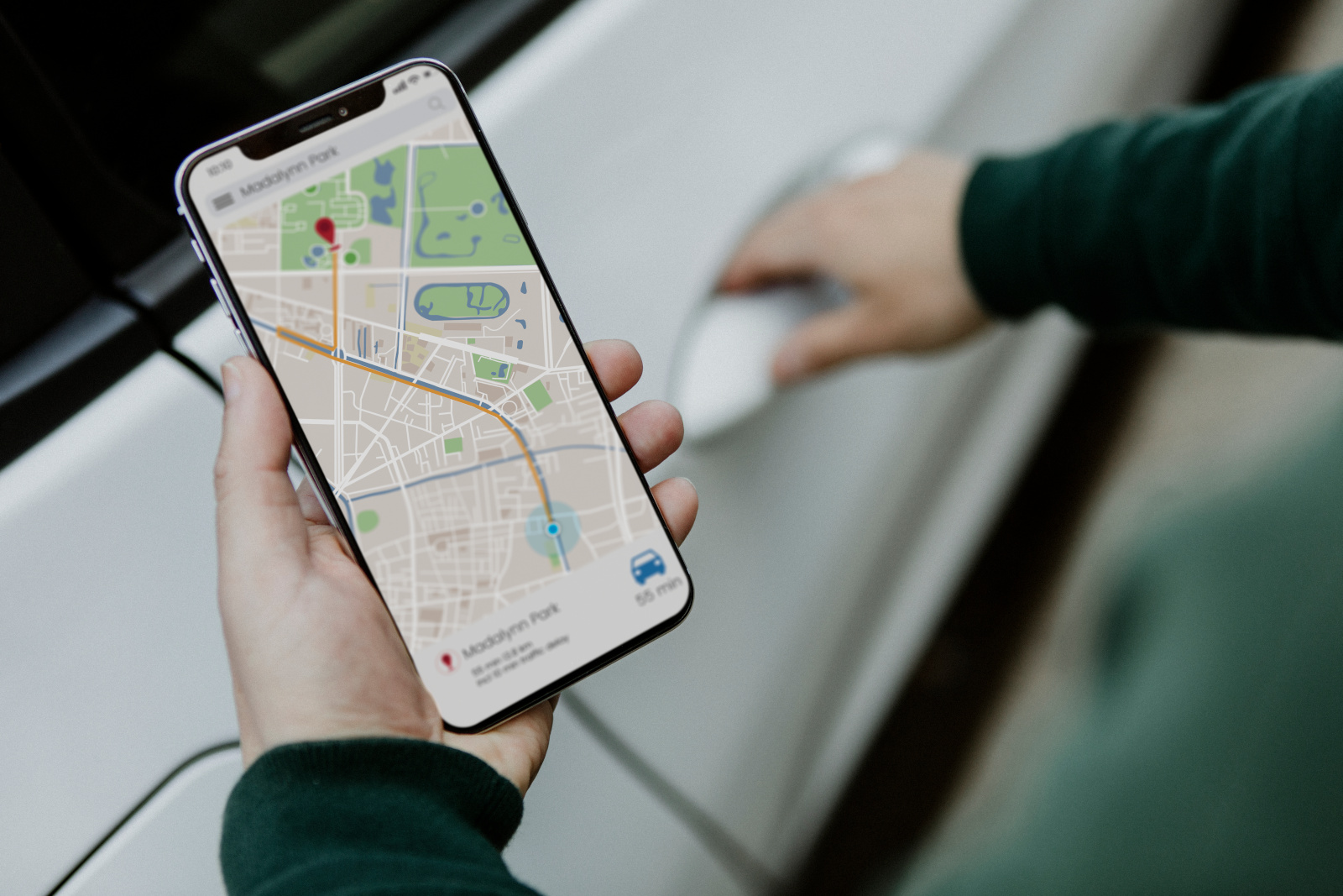 Person opening car door and holding Smartphone using GPS map select on screen: NestForms Offline Surveys