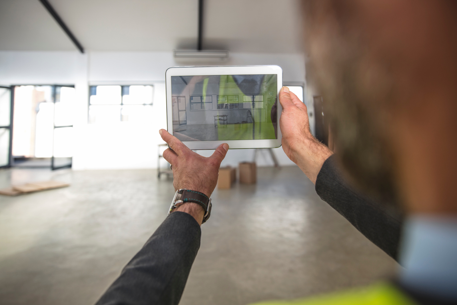 Site inspector taking an image of completed phase of work using a project handover checklist form created with NestForms