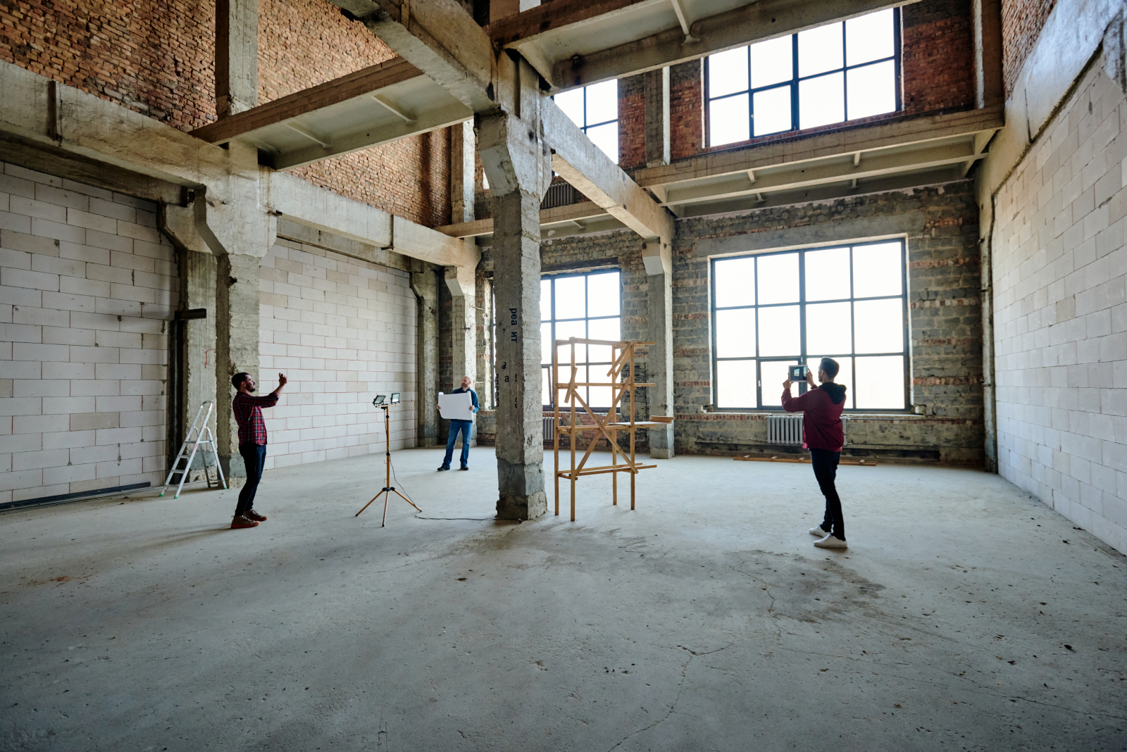 Architects and contractors involved in building renovation project management with tablets using the NestForms Snag list app