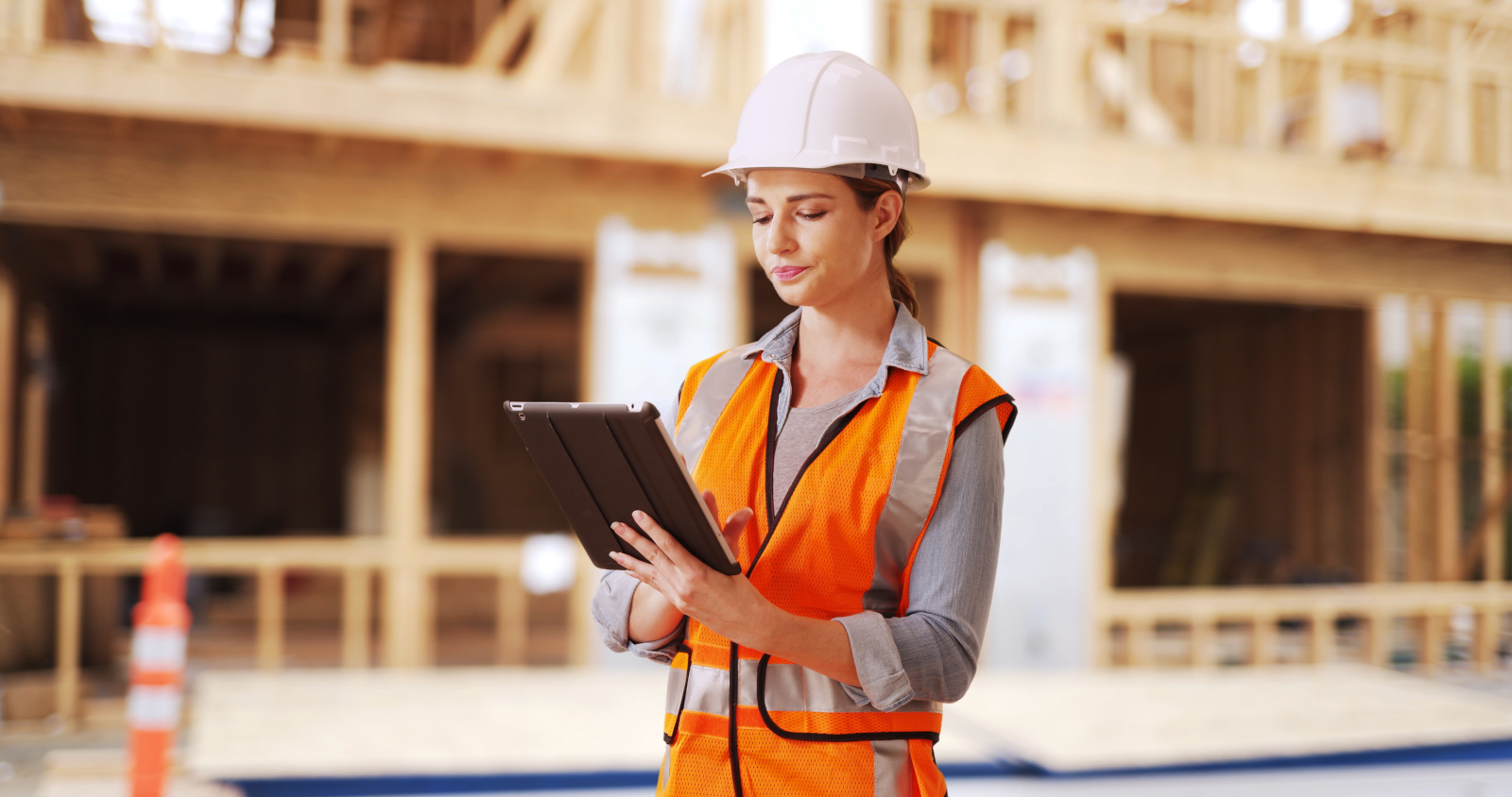 Female construction worker on site using the NestForms offline survey app