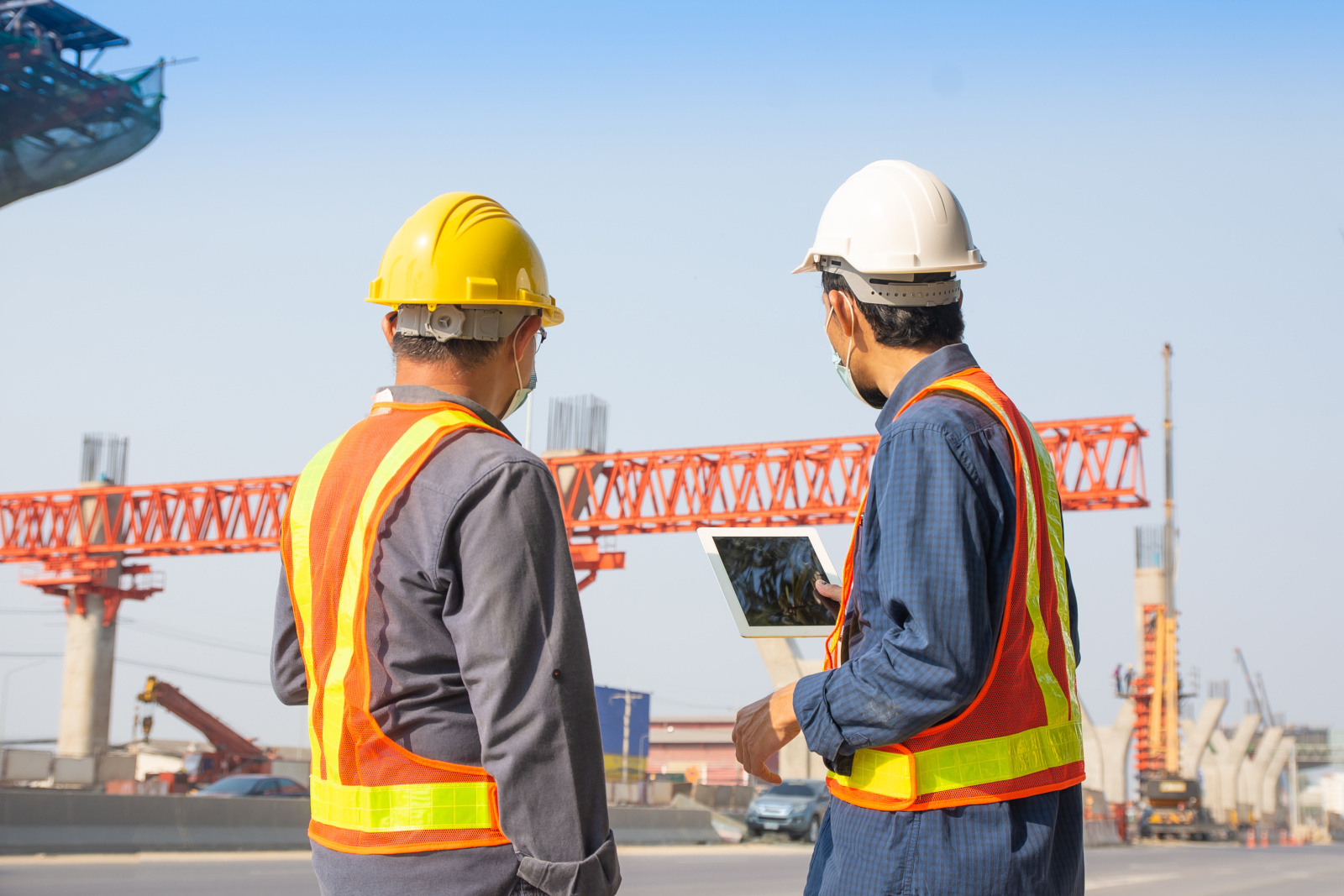 Two industrial construction inspectors using The NestForms mobile form app on large project