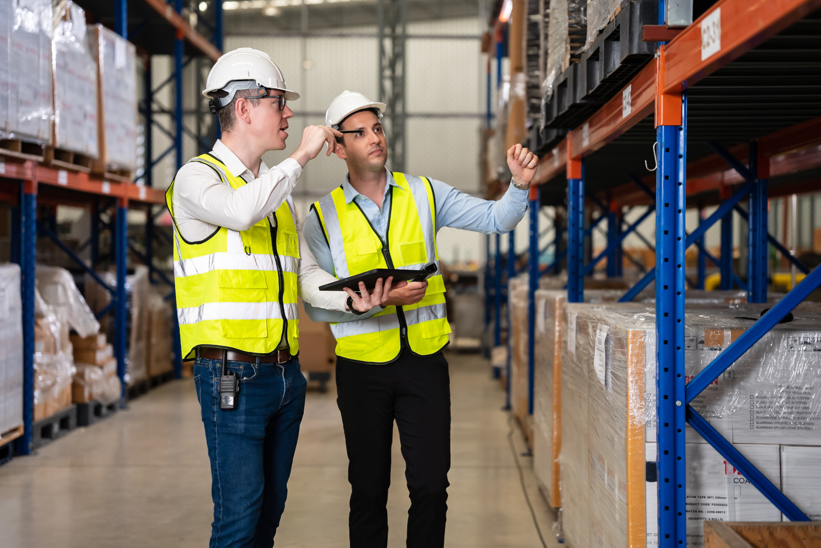 The NestForms mobile form app: two Health and Safety officers with tablet carrying out an inspection in a warehouse aisle