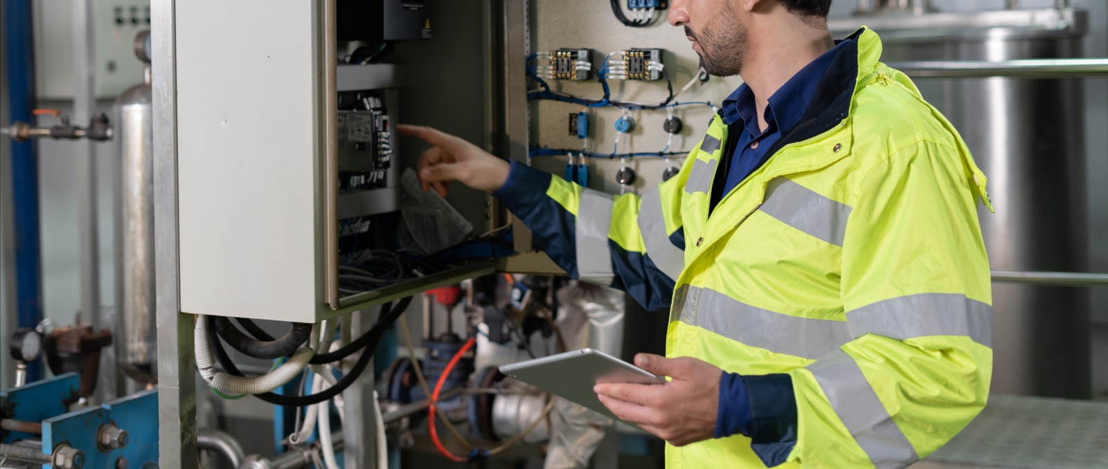 Health and Safety Officer entering machinery gauge readings onto mobile app