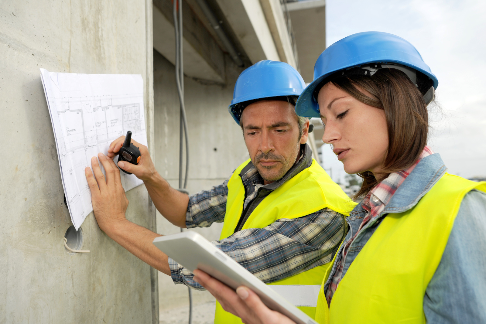 Two construction workers using data from the NestForms Punch List app